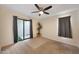 Comfortable bedroom with a ceiling fan, neutral walls, and sliding glass doors to the exterior at 850 S River Dr # 1047, Tempe, AZ 85281
