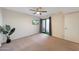 Inviting bedroom features a sliding door to a patio, plush carpeting, and a ceiling fan at 850 S River Dr # 1047, Tempe, AZ 85281