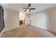 Spacious bedroom with neutral carpet, ceiling fan, and ensuite bathroom with vanity area at 850 S River Dr # 1047, Tempe, AZ 85281