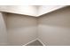 Walk-in closet featuring carpet flooring, ample shelving for optimal storage, and neutral paint at 850 S River Dr # 1047, Tempe, AZ 85281