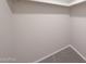 Walk-in closet featuring carpet flooring, ample shelving for optimal storage, and neutral paint at 850 S River Dr # 1047, Tempe, AZ 85281