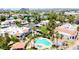Aerial view showcases a community pool, hot tub, with nearby residential buildings and lush landscaping at 850 S River Dr # 1047, Tempe, AZ 85281