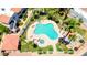 An aerial view displays a community pool with a connected jacuzzi and landscaping at 850 S River Dr # 1047, Tempe, AZ 85281