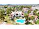 Aerial view of a community pool surrounded by well-maintained landscaping and several residential buildings at 850 S River Dr # 1047, Tempe, AZ 85281