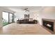 Spacious living room featuring a cozy fireplace, ceiling fan, and sliding glass doors to a patio at 850 S River Dr # 1047, Tempe, AZ 85281