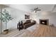 Comfortable living room featuring a fireplace, ceiling fan and a brown leather sofa at 850 S River Dr # 1047, Tempe, AZ 85281