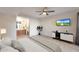 Bright main bedroom with a ceiling fan, a television, a houseplant, and an ensuite bathroom at 850 S River Dr # 1047, Tempe, AZ 85281