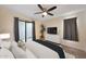 Bright main bedroom with a ceiling fan, a television, a houseplant, and access to the outdoor patio at 850 S River Dr # 1047, Tempe, AZ 85281