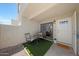 Charming patio features outdoor seating and a welcoming entrance; artificial turf adds a touch of green at 850 S River Dr # 1047, Tempe, AZ 85281