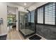 Elegant bathroom boasting a glass-enclosed shower with gray tile and a window with stylish shutters at 10033 W Jessie Ln, Peoria, AZ 85383