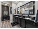 Bathroom with a double sink vanity, black countertops and two mirrors at 10033 W Jessie Ln, Peoria, AZ 85383