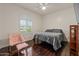 Bright bedroom features hardwood floors, a cozy chair, and a large window with natural light at 10033 W Jessie Ln, Peoria, AZ 85383