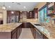 Kitchen with dark cabinets, granite countertops, tiled backsplash, and stainless steel appliances at 10033 W Jessie Ln, Peoria, AZ 85383