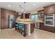 Kitchen with dark cabinets, stainless steel appliances, and granite countertop island at 10033 W Jessie Ln, Peoria, AZ 85383