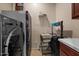 Functional laundry room featuring a modern washer, ample storage space, and convenient laundry carts at 10033 W Jessie Ln, Peoria, AZ 85383