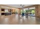 Open-concept living room with a large sliding glass door to the outdoor patio at 10033 W Jessie Ln, Peoria, AZ 85383
