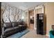 Cozy living room showcasing a decorative accent wall, comfortable seating, and sliding barn doors at 10033 W Jessie Ln, Peoria, AZ 85383