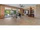 Open-concept living room with tile floors, a ceiling fan, and a cozy living space, perfect for entertaining at 10033 W Jessie Ln, Peoria, AZ 85383