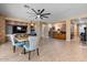 Open-concept living room featuring tile floors, ceiling fan, and stone accents at 10033 W Jessie Ln, Peoria, AZ 85383