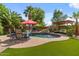 Beautiful pool featuring a waterfall, lounging chairs and a pergola surrounded by lush green landscaping at 10033 W Jessie Ln, Peoria, AZ 85383