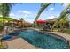 Stunning backyard pool with a volleyball net, lounge chairs, a waterfall feature and manicured landscaping at 10033 W Jessie Ln, Peoria, AZ 85383