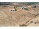 Large parcel of land with single story residence, surrounded by desert landscape and nearby homes at 11192 N Johnson Rd, Maricopa, AZ 85139