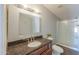 Bathroom featuring granite countertop vanity, large mirror, and a glass enclosed shower at 11192 N Johnson Rd, Maricopa, AZ 85139