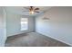 Simple bedroom with carpet flooring, soft gray walls, and abundant natural light at 11192 N Johnson Rd, Maricopa, AZ 85139