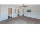 Carpeted bedroom featuring ceiling fan and ensuite bathroom and closet at 11192 N Johnson Rd, Maricopa, AZ 85139