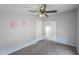 Comfortable bedroom with ceiling fan, plush carpet, and white closet doors at 11192 N Johnson Rd, Maricopa, AZ 85139