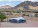 Aerial shot of a single-story home with mountain views, showcasing desert landscape at 11192 N Johnson Rd, Maricopa, AZ 85139