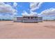 A single-story home with a front porch, surrounded by desert landscape and a blue sky background at 11192 N Johnson Rd, Maricopa, AZ 85139
