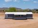 Exterior daytime view of a single-story home, showcasing the front entrance and desert landscape at 11192 N Johnson Rd, Maricopa, AZ 85139
