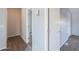 Bright hallway featuring wood and carpeted flooring with neutral walls at 11192 N Johnson Rd, Maricopa, AZ 85139