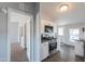 Kitchen features white cabinetry, stainless steel appliances, and dark laminate flooring at 11192 N Johnson Rd, Maricopa, AZ 85139