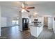 Bright, open kitchen with a central island and modern appliances, flowing into the living area at 11192 N Johnson Rd, Maricopa, AZ 85139