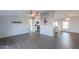 Bright and airy living room featuring neutral decor, ceiling fan, and wood-look floors at 11192 N Johnson Rd, Maricopa, AZ 85139