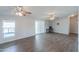 Spacious living room with hardwood floors, ceiling fans, and sliding glass doors at 11192 N Johnson Rd, Maricopa, AZ 85139