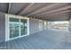 Covered patio features gray carpet, views, and access to the home through sliding glass doors at 11192 N Johnson Rd, Maricopa, AZ 85139