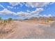 Wide shot of the acreage, mountain view, and desert landscape and the single story home at 11192 N Johnson Rd, Maricopa, AZ 85139