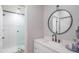 Bright bathroom featuring a modern vanity, round mirror, and walk-in shower at 11333 N 92Nd St # 1075, Scottsdale, AZ 85260