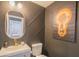 Stylish half-bath with striking dark walls, geometric design, and modern gold fixtures at 11333 N 92Nd St # 1075, Scottsdale, AZ 85260