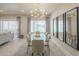 Bright dining area with modern light fixture, glass table, and elegant mirrors at 11333 N 92Nd St # 1075, Scottsdale, AZ 85260