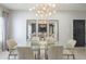 Dining area featuring a modern chandelier, glass table, and mirrored wall decor at 11333 N 92Nd St # 1075, Scottsdale, AZ 85260