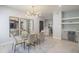 Open dining room with a glass table, modern light, and views into the kitchen at 11333 N 92Nd St # 1075, Scottsdale, AZ 85260