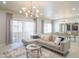 Open-concept living area with stylish sofa, lighting, and access to a balcony at 11333 N 92Nd St # 1075, Scottsdale, AZ 85260