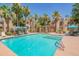Relaxing community pool with lounge chairs, palm trees, and shade structures for a resort-style living experience at 11333 N 92Nd St # 1075, Scottsdale, AZ 85260