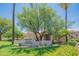 Community signage amid manicured landscaping, complemented by mature trees and colorful flowers at 11333 N 92Nd St # 1075, Scottsdale, AZ 85260