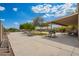 Expansive backyard with a covered patio area, grill, picnic table, and ample space for outdoor entertaining at 1145 E Harold Dr, San Tan Valley, AZ 85140