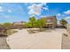 Spacious backyard featuring lush trees, a fire pit, a basketball hoop, and a covered patio for relaxation at 1145 E Harold Dr, San Tan Valley, AZ 85140